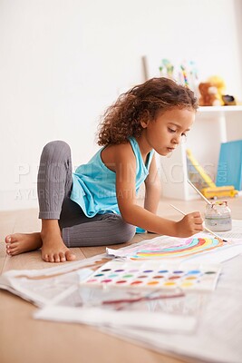 Buy stock photo Kindergarten, education or girl painting a rainbow on classroom floor for creative, learning or child development. Paper, color splash or sweet kid with school art paint, sketch or having fun drawing