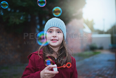 Buy stock photo Child, happy and blowing bubbles for outdoor playing with holiday fun in winter, childhood or development. Girl, kid and smiling outside in cold weather as preschool student, joyful or positivity