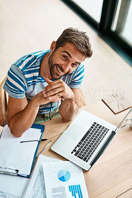 Buy stock photo Man, portrait and above with laptop in home office for work as freelance web or graphic designer. Male person, documents and data report for performance metrics, budget tracking and website progress.