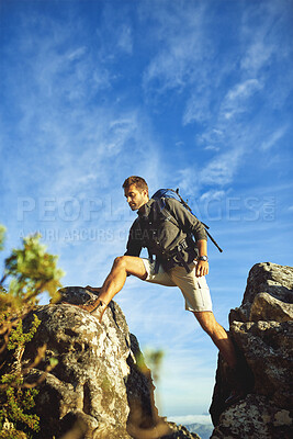 Buy stock photo Man, cliff and hiking with backpack outdoor for fitness adventure, sports challenge and travel journey. Male person, rocks and trekking balance with climbing mountain, exercise and nature activity