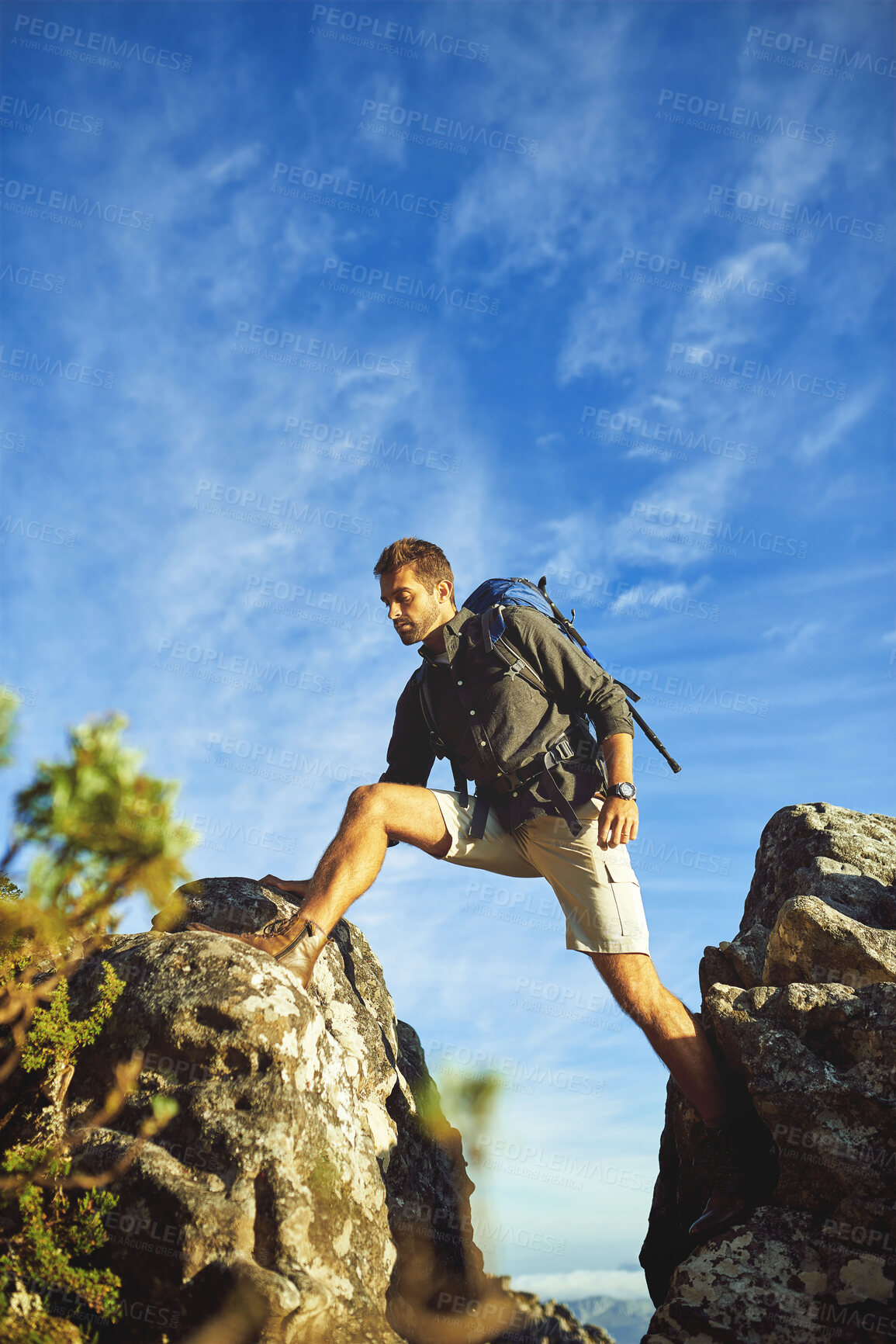 Buy stock photo Man, cliff and hiking with backpack outdoor for fitness adventure, sports challenge and travel journey. Male person, rocks and trekking balance with climbing mountain, exercise and nature activity