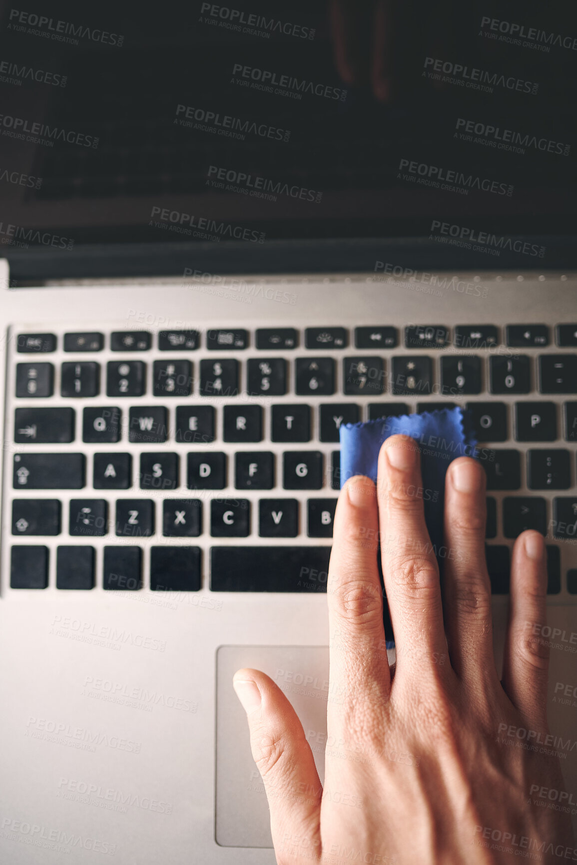 Buy stock photo Hands, person and cleaning laptop with cloth for keyboard dirt, germ removal or dust bacteria for wellness. Hygiene, top view or disinfect technology for responsibility, routine or keypad maintenance