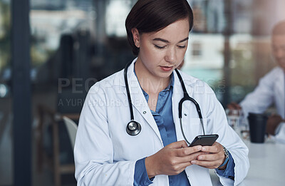 Buy stock photo Hospital, phone and doctor with typing in office for telehealth, healthcare website and research. Medical professional, clinic and woman with smartphone for digital consulting, service and network
