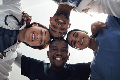 Buy stock photo Doctors, circle and below in portrait with group, diversity or solidarity in medical career at hospital. Medic team building, men and women in collaboration, wellness or huddle for healthcare service