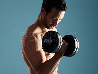 Buy stock photo Fitness, studio and man workout with dumbbell for training, exercise and growth for wellness. Muscle, shirtless bodybuilder and weightlifting for strong bicep, power and energy on blue background