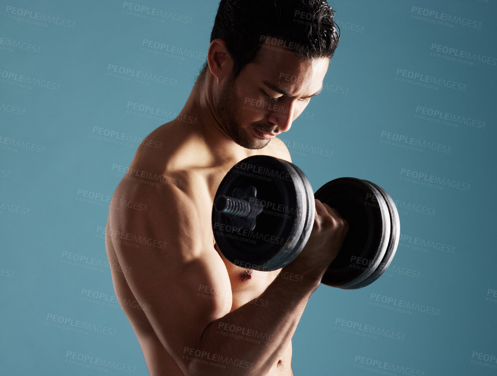 Buy stock photo Fitness, studio and man workout with dumbbell for training, exercise and growth for wellness. Muscle, shirtless bodybuilder and weightlifting for strong bicep, power and energy on blue background