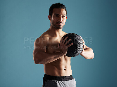 Buy stock photo Fitness, portrait and man workout with medicine ball for training, exercise or health. Muscle, shirtless or strong bodybuilder with equipment, confidence or determined on blue studio background space