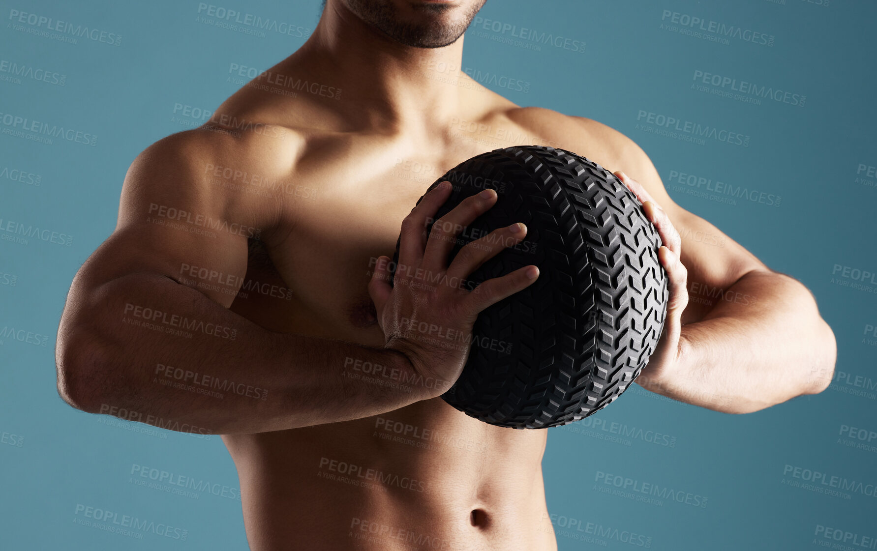 Buy stock photo Fitness, hands and man with medicine ball for training, exercise or workout for health. Muscle, shirtless and strong bodybuilder with equipment for growth, weight and power on blue studio background