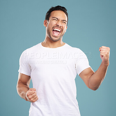 Buy stock photo Scream, man and excited in studio with fist pump, celebration and achievement for winning prize. Hand gesture, male person and winner with cheering for bonus, discount or yes shout by blue background