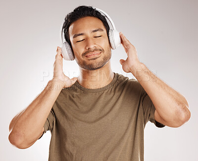 Buy stock photo Studio, man and calm with headphones for sound, podcast and satisfied with playlist for motivation. Relax, male person and model for listening to audio, streaming music and radio by white background