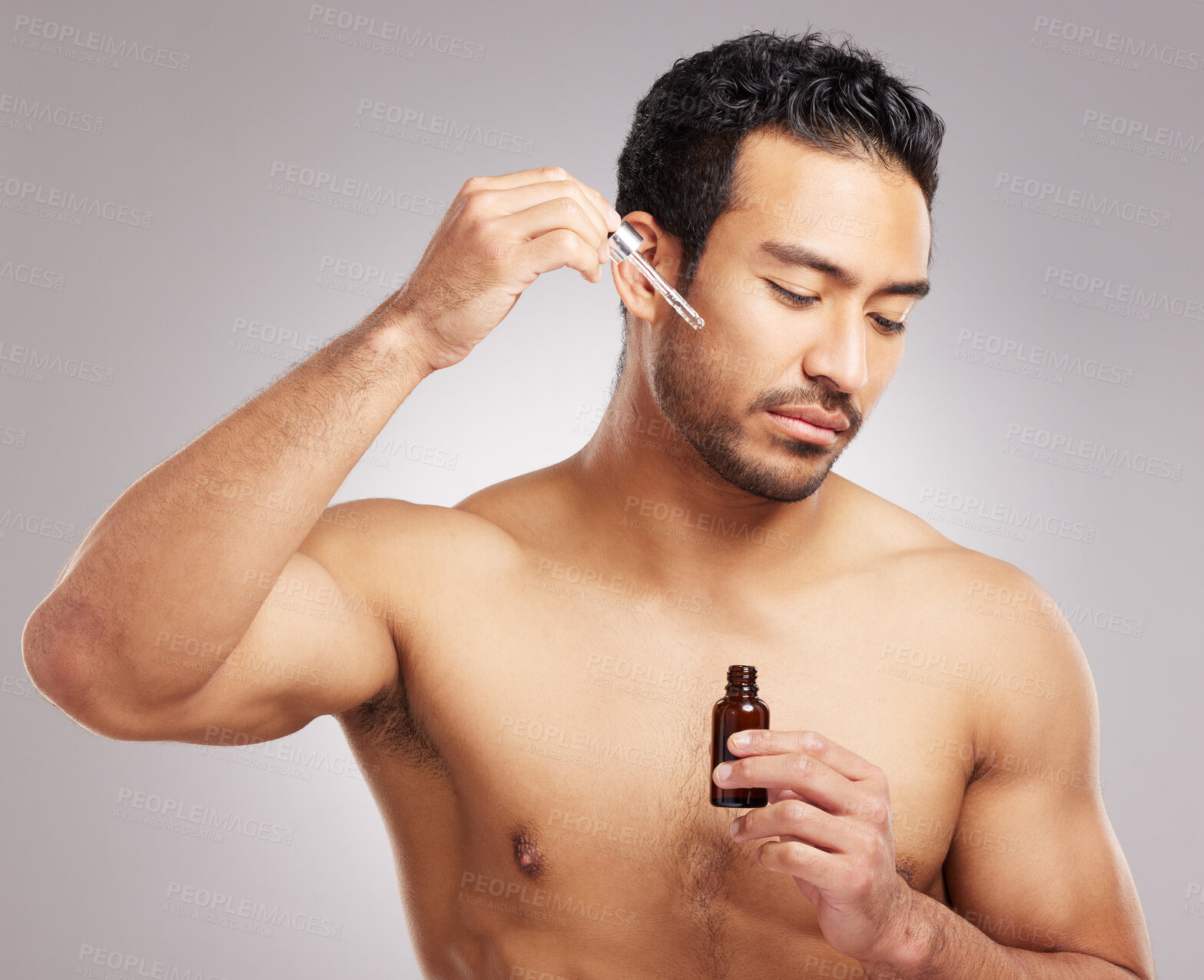 Buy stock photo Skincare, man and serum oil in studio for skin hydration, anti aging treatment and collagen. Topless person, cosmetic dropper or dermatology product for natural face moisturizer on gray background