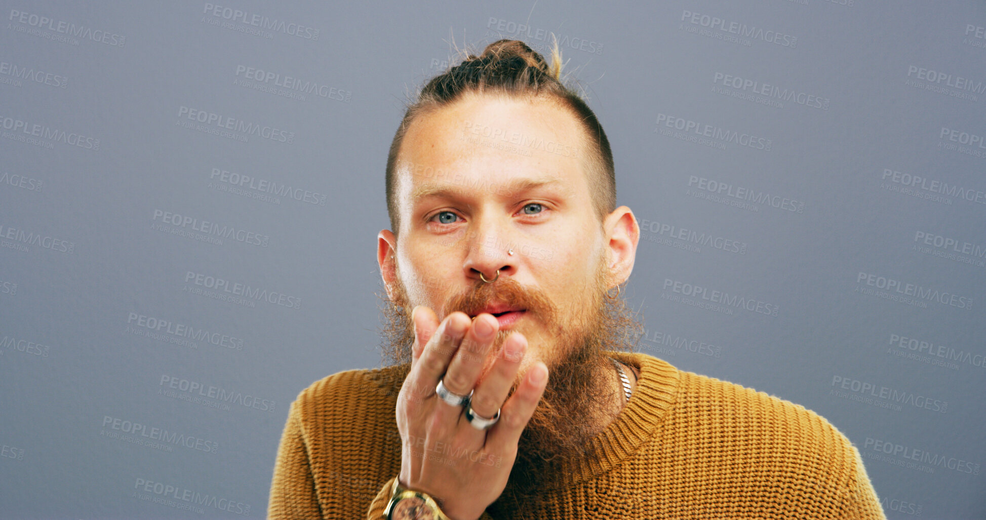 Buy stock photo Man, portrait and blowing with kiss for love, romance or affection on a gray studio background. Male person, face or model with beard, hand or romantic gesture for distant compassion on mockup space