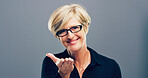 Mature, portrait and happy woman with glasses in studio for creative development on a gray background. Face, female person or designer with smile, frame or lens for sight or optometry on mockup space