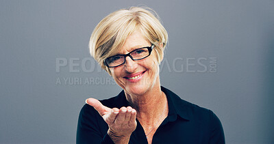 Buy stock photo Mature, portrait and woman with glasses in studio for creative development on a gray background. Face, female person or designer with smile, frame or lens for sight or optometry on mockup space