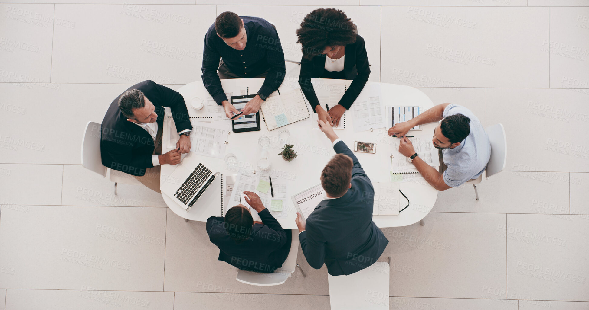 Buy stock photo Above, meeting and handshake with business people in office for budget proposal, schedule and agreement. Project management, documents and technology with teamwork for paperwork, strategy or campaign