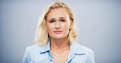 Buy stock photo Sad, emotional and woman with heartbreak, studio and crying for loss of relationship, divorce and grief. Mockup space, blue background and person with depression for breakup, disappointed and lonely