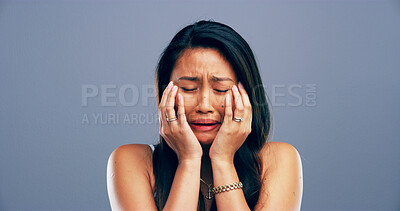 Buy stock photo Unhappy, woman and sad with crying in studio for mental health, pain and grief with mockup space. Emotional, bad news and person with depression on gray background for mourning, sorrow and trauma