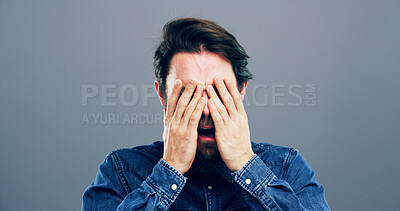 Buy stock photo Sad, man and crying with tears in studio of depression, mourning loss and emotional for memory. Male person, grief and cover face for mental health crisis, bad news and ptsd trauma on gray background