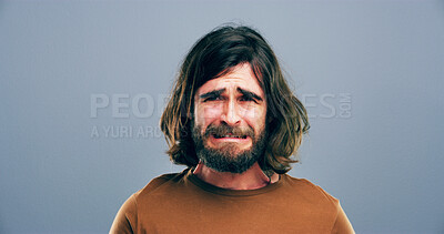 Buy stock photo Crying, sad and portrait of man in studio with grief, heartbreak and emotional on blue background. Tears, mourning or space at person with depression, upset and unhappy for breakup, bad news and pain