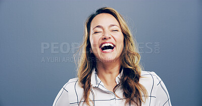 Buy stock photo Studio, woman and freedom with laughing for joke, funny and confident with comedy by mockup space. Model, female person and happiness with humor by blue background, satisfaction and emoji reaction