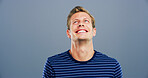 Smile, space and thinking with man in studio for contemplation, memories or nostalgia. Idea, inspiration and mockup with happy model isolated on gray background for future, planning or vision