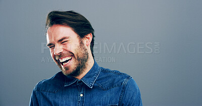 Buy stock photo Laughing, joke and face of man in studio for comic, funny and silly with mockup space. Happiness, goofy meme and comedy with male person on blue background for smile, humor and giggle reaction