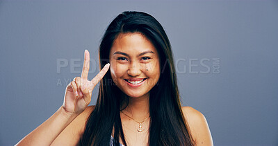 Buy stock photo Asian woman, peace sign and portrait in studio with smile, icon and v symbol for victory by background. Girl, person and happy with emoji, fashion and vote for human rights with hand gesture in China