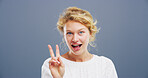 Portrait, smile and woman with peace sign, studio and happy for scholarship in college and excited. Blue background, mockup space and person with gesture for opportunity, student or university in USA