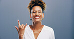 Portrait, woman and rock on sign at studio for music, heavy metal and cool emoji for culture isolated on background. Smile, devil horns and person with symbol, hand gesture and punk for social media