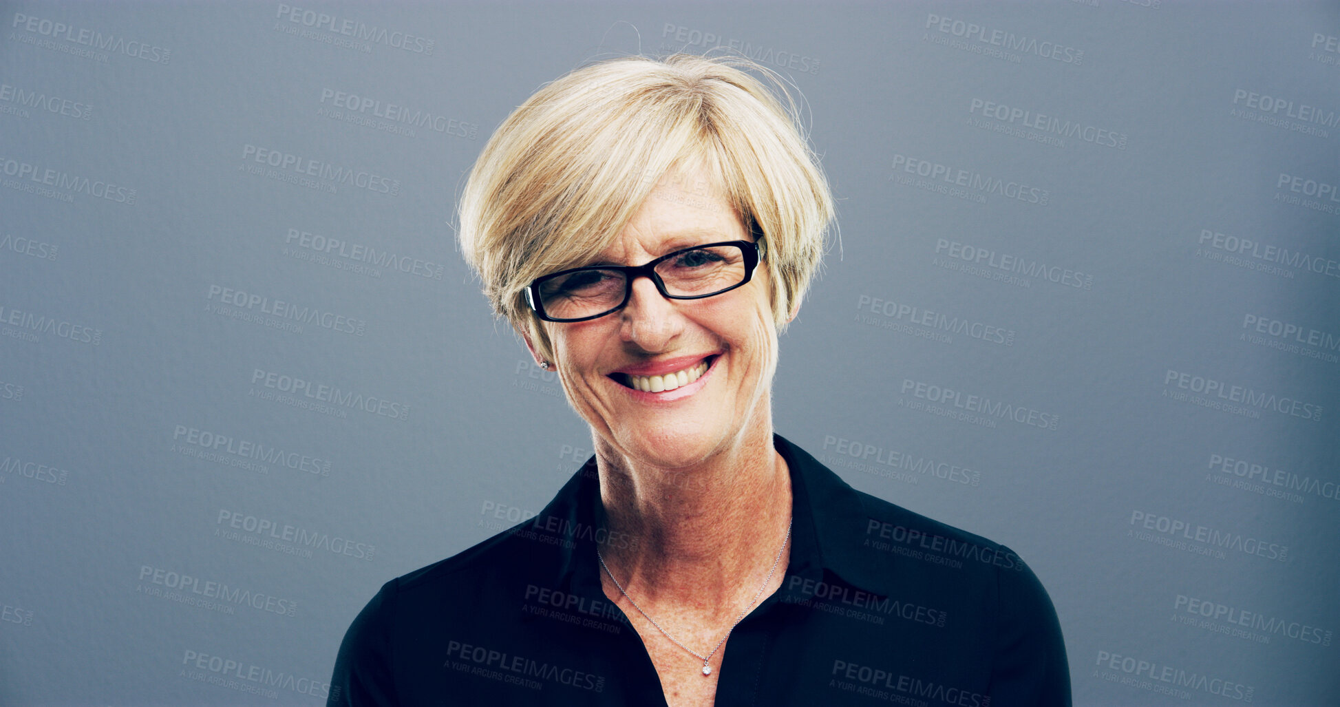 Buy stock photo Happy, portrait and mature businesswoman in studio with confidence for corporate career. Glasses, pride and female human resources manager from London with company compliance by gray background.
