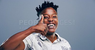 Buy stock photo Happy, black man or portrait with thumbs up for positive reaction on a gray studio background. Face, male person or Nigerian model with smile, like emoji or yes sign for OK, approval or satisfaction