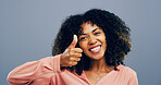 Happy woman, portrait and feedback with thumbs up for positive reaction on a gray studio background. Female person, model or smile with like emoji, gesture or yes sign for approval or satisfaction