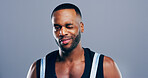 Portrait, wink and black man in studio, fitness and support on blue background. African person, bodybuilder and athlete with expression, motivation for training and greeting with gesture or thank you