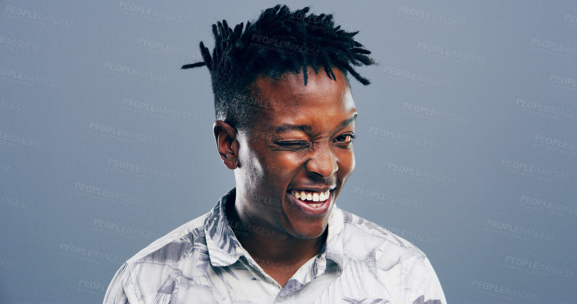 Buy stock photo Wink, secret and portrait of black man in studio for smile, agreement and joke gesture. Happiness, comic feedback and thank you with male person on background for review, comedy and funny sign