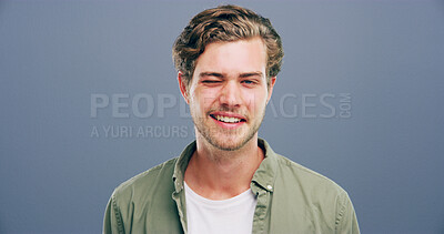 Buy stock photo Wink, smile and flirt with portrait of man in studio for secret, agreement and support gesture. Happiness, rumour and gossip with person on background for discount review, space and well done sign