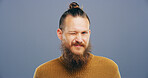 Wink, hipster and portrait of man in studio for secret, agreement and support gesture. Happiness, feedback and thank you with male person on background for review, achievement and well done sign