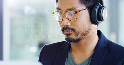 Buy stock photo Asian man, glasses and headphones with music for creative development or web design at office. Male person, businessman or designer with spectacles for sight, vision or company research at workplace