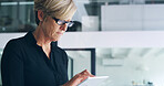 Business, tablet and mature woman in office, typing and internet with website information. Person, financial advisor and employee in workplace, tech and network with digital app for trading and email