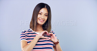 Buy stock photo Smile, heart hands and portrait of woman in studio for love, support and kindness. Happiness, valentines day sign and mockup space with female  person on white background for emoji, hope and care