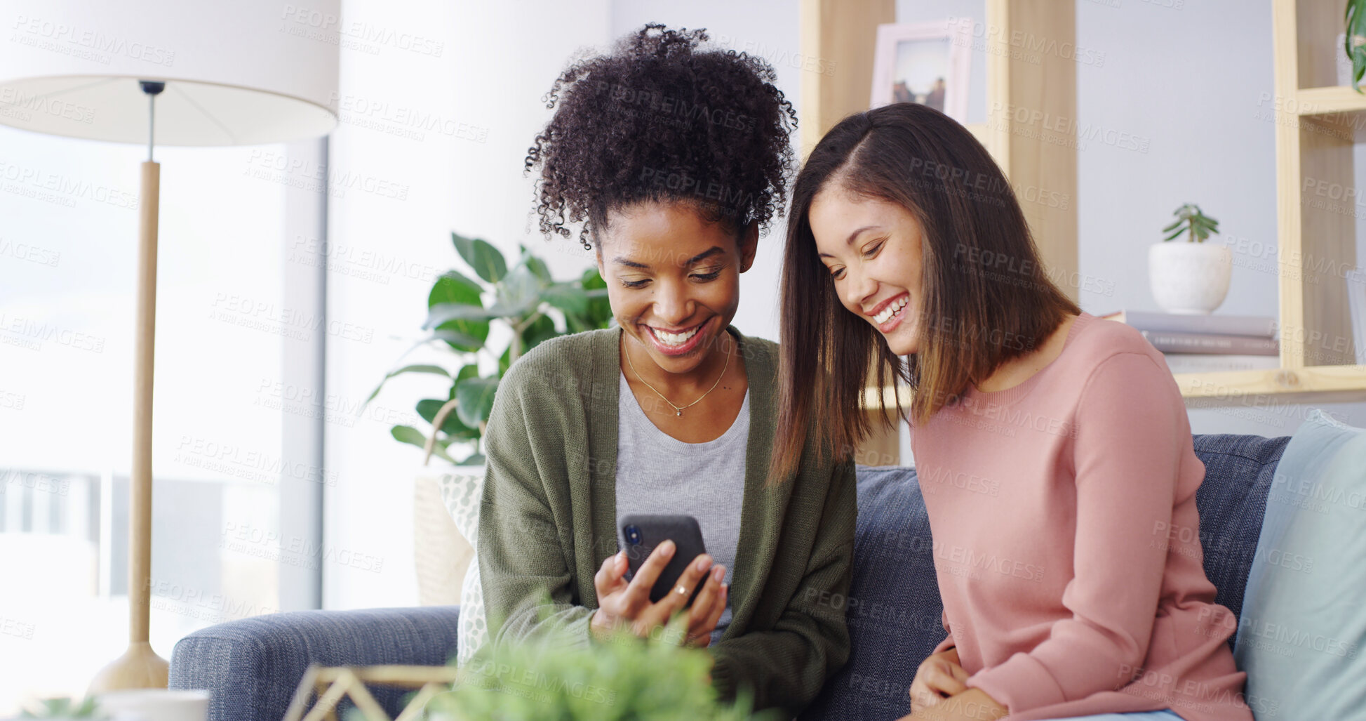 Buy stock photo Home, friends and laughing with mobile for social media, funny video and bonding together on sofa. House, happy people and women with smartphone for meme application, joke reel and relax with gossip