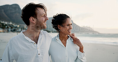 Buy stock photo Holiday, travel and interracial couple embrace at beach for love, care or holding hands for relationship. Ocean, happy man and woman outdoor for vacation, laugh or romantic date with view of space