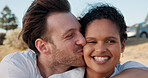 Kiss, love and smile with couple at beach for travel vacation, bonding and romantic date. Happiness, summer holiday and marriage anniversary with man and woman outdoors for relax, adventure and hug