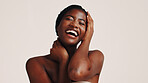 Skincare, laugh and black woman in studio with beauty, health or wellness routine. Happy, natural and African female person with dermatology facial treatment for face glow by white background.