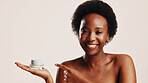 Happy, black woman and portrait with lotion in studio for hydration, treatment and sunscreen protection. Female person, cream and spf cosmetics for facial dermatology, anti aging and white background