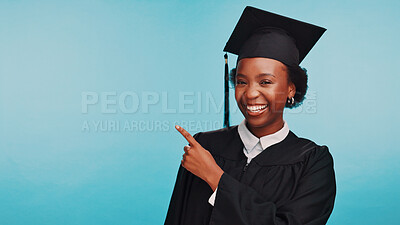 Buy stock photo Black woman, graduation and point in studio portrait, education and mock up space by blue background. Girl, college student and smile with choice, achievement and success with celebration in Kenya