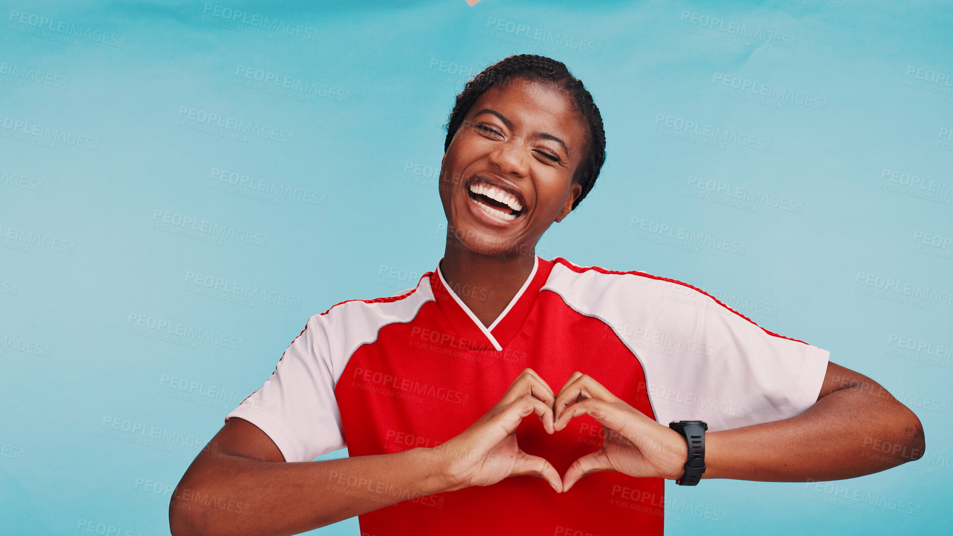 Buy stock photo Portrait, heart hands and woman in studio, soccer player and symbol for love on blue background. African person, model and athlete with gesture, sports and support with female empowerment or kindness