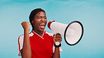 Woman, loudspeaker and celebration in studio with sports for fist pump, goal or soccer by blue background. African athlete, girl and bullhorn for cheers, motivation or support for football tournament