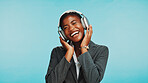 Headphones, music and business black woman in studio to relax with audio, track and playlist. Professional, corporate worker and person dance listening to radio, song and streaming on blue background
