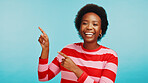 Portrait, advertising and black woman with pointing in studio for marketing info, sale opportunity and promotion deal. Offer, ambassador or smile with mockup space for coming soon on blue background