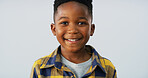 Portrait, happy black child and boy in studio with calm adorable model isolated on white background. Face, smile and young African kid with confidence, positive and growth for development in Nigeria
